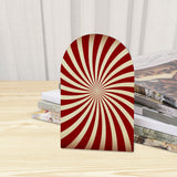Close-up of the Red Sunburst retro wooden bookend beside stacked magazines
