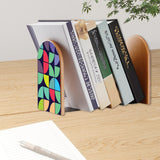 Geometric Tiles retro bookend holding books on a wooden desk next to a pen