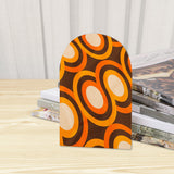 Close-up of the Orange Rings retro wooden bookend beside stacked magazines