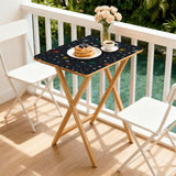 Atomic Stars Black retro TV tray set of 4, on a balcony with coffee and pastries