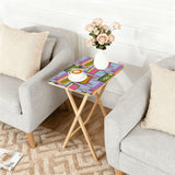 Atomic TV Lilac retro TV tray set of 4, next to a grey sofa with flowers