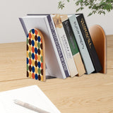 Multicolor Dots retro bookend holding books on a wooden desk next to a pen