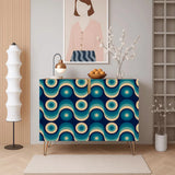Retro wooden cabinet with blue and teal retro circle doors and hairpin legs beside a tall white floor lamp and framed art