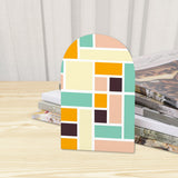 Close-up of the Teal Peach Blocks retro wooden bookend beside stacked magazines
