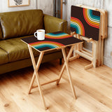 Rainbow Arcs 70s retro TV tray set of 4, in a living room beside an olive sofa