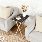 Botanical Black retro TV tray set of 4, next to a grey sofa with flowers