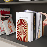 Red Sunburst retro wooden bookend on a dark shelf with books
