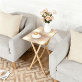 Beige Plaid retro TV tray set of 4, next to a grey sofa with flowers