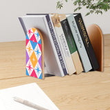 Star Diamonds retro bookend holding books on a wooden desk next to a pen