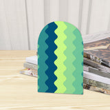 Close-up of the Green Zigzag retro wooden bookend beside stacked magazines