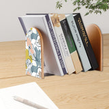 Botanical Leaf retro bookend holding books on a wooden desk next to a pen