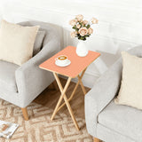 Apricot retro TV tray set of 4, next to a grey sofa with flowers