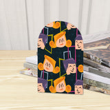 Close-up of the Quirky Faces retro wooden bookend beside stacked magazines
