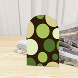 Close-up of the Green Dots retro wooden bookend beside stacked magazines