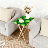 Green Peacock Eye retro TV tray set of 4, next to a grey sofa with flowers