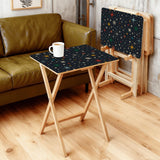 Atomic Stars Black retro TV tray set of 4, in a living room beside an olive sofa