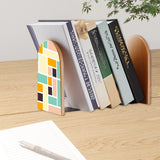 Teal Peach Blocks retro bookend holding books on a wooden desk next to a pen