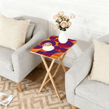 Sunset Geometric retro TV tray set of 4, next to a grey sofa with flowers