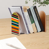 Rainbow Stripe retro bookend holding books on a wooden desk next to a pen