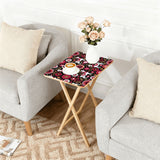 Nordic Folk Pink retro TV tray set of 4, next to a grey sofa with flowers