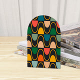 Close-up of the Multicolor Arches retro wooden bookend beside stacked magazines