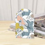 Close-up of the Botanical Leaf retro wooden bookend beside stacked magazines