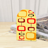 Close-up of the Mod Rectangles retro wooden bookend beside stacked magazines