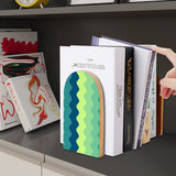 Green Zigzag retro wooden bookend on a dark shelf with books