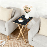 Atomic Stars Black retro TV tray set of 4, next to a grey sofa with flowers