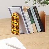 Orange Clover retro bookend holding books on a wooden desk next to a pen