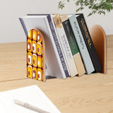 Amber Squares retro bookend holding books on a wooden desk next to a pen