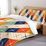 Atomic harlequin duvet cover set on a bed with a white sheet and a wooden bedside table