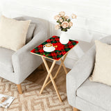 Poinsettia Plaid retro TV tray set of 4, next to a grey sofa with flowers