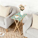 Atomic Cat Teal retro TV tray set of 4, next to a grey sofa with flowers