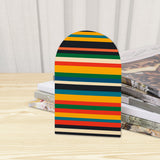 Close-up of the Rainbow Stripe retro wooden bookend beside stacked magazines