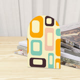 Close-up of the Orange Mod Shapes retro wooden bookend beside stacked magazines