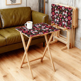 Nordic Folk Pink retro TV tray set of 4, in a living room beside an olive sofa