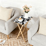 Black White Deer retro TV tray set of 4, next to a grey sofa with flowers