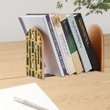 Novelty Shapes retro bookend holding books on a wooden desk next to a pen