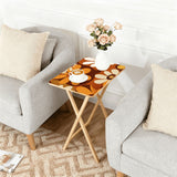 Brown Orange Daisies retro TV tray set of 4, next to a grey sofa with flowers