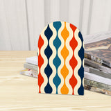 Close-up of the Wave Lines retro wooden bookend beside stacked magazines