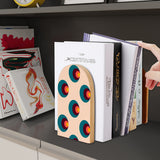 Target Dots retro wooden bookend on a dark shelf with books