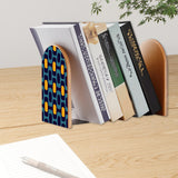 Navy Gold Ovals retro bookend holding books on a wooden desk next to a pen