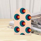 Close-up of the Target Dots retro wooden bookend beside stacked magazines