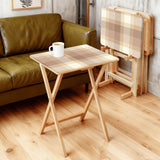 Beige Plaid retro TV tray set of 4, in a living room beside an olive sofa