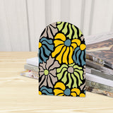 Close-up of the Yellow Abstract Floral retro wooden bookend beside stacked magazines