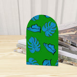 Close-up of the Tropical Leaf retro wooden bookend beside stacked magazines
