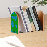 Tropical Leaf retro bookend holding books on a wooden desk next to a pen