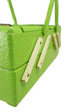 Vintage 1950s lime green sewing or jewelry box – close-up of the textured finish and an ivory strut