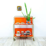 Iconic orange golden 1970s FOLDABLE BAR CART 'Dinett' by Bremshey